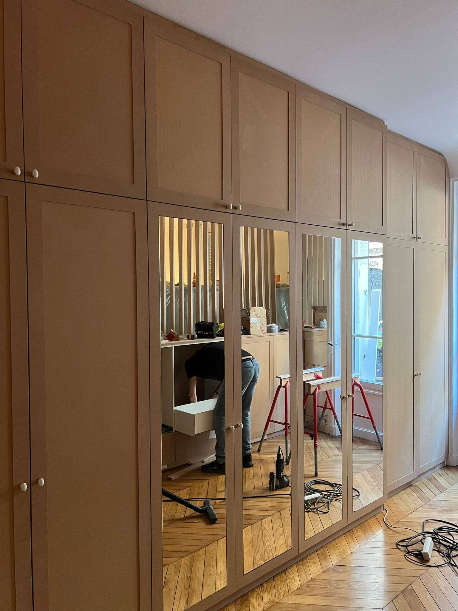 Dressing sur mesure à portes moulurées et miroirs, en cours de finition, à Paris 10e